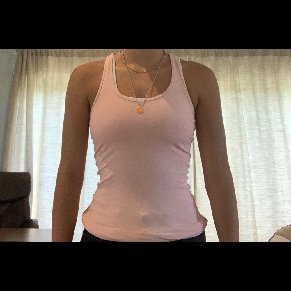 This is a light pink Lululemon tank top that is in great condition. reversible